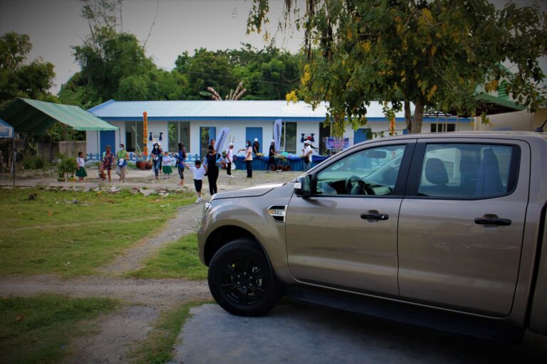 We cannot resist taking a photo of the Ford Ranger with the new single-story 3-classroom building. Getting those happy children and parents in the photo was a bonus.